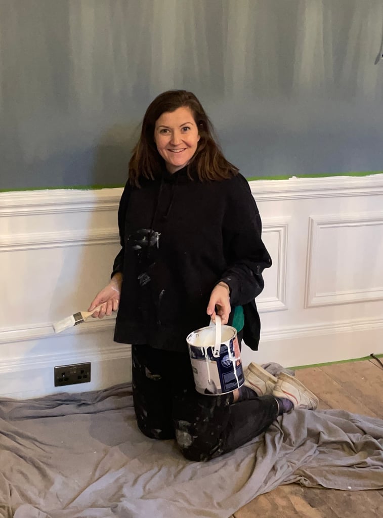 This is Hannah when she renovated Pheasant Lodge. She has a paint can and brush in hand and is working on the lounge.