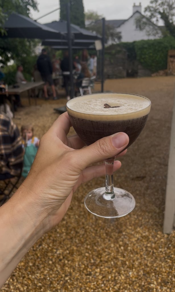 Espresso Martini cocktail in a pub beer garden in the Lake District in the rain
