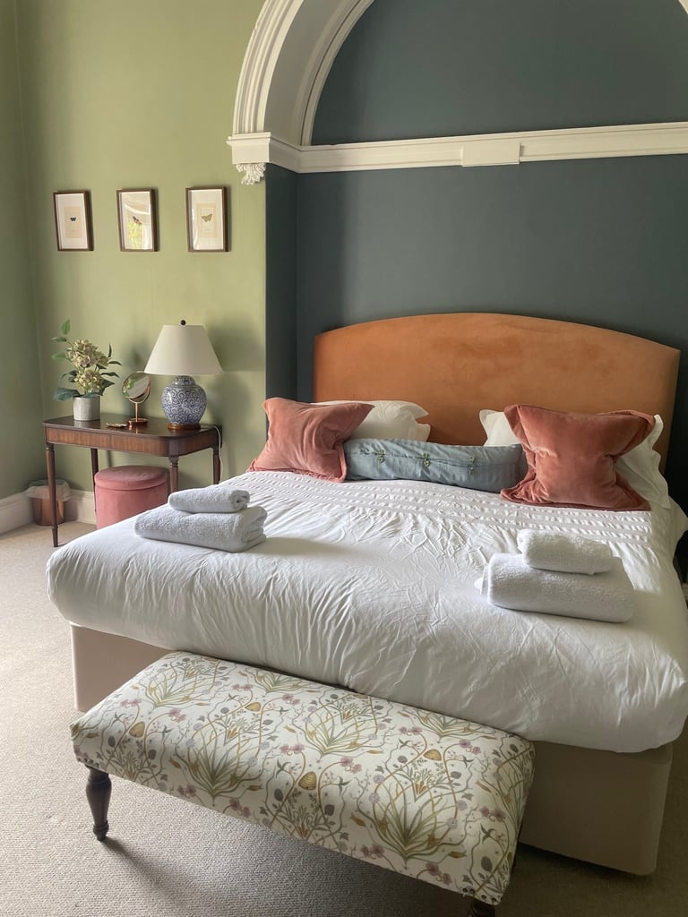 Master bedroom with superking bed in a Lake District Holiday home. Towels set up on the ned ready for guests