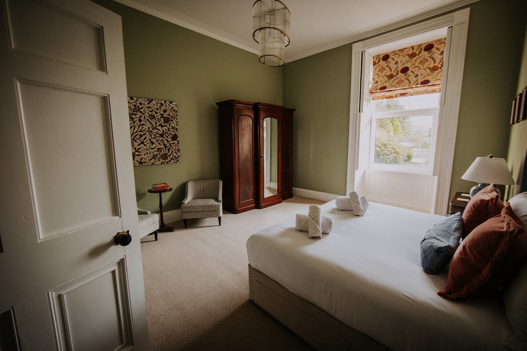 Large master bedroom with garden views. Superking bed in room, large wardbrobe, large window and seating area.