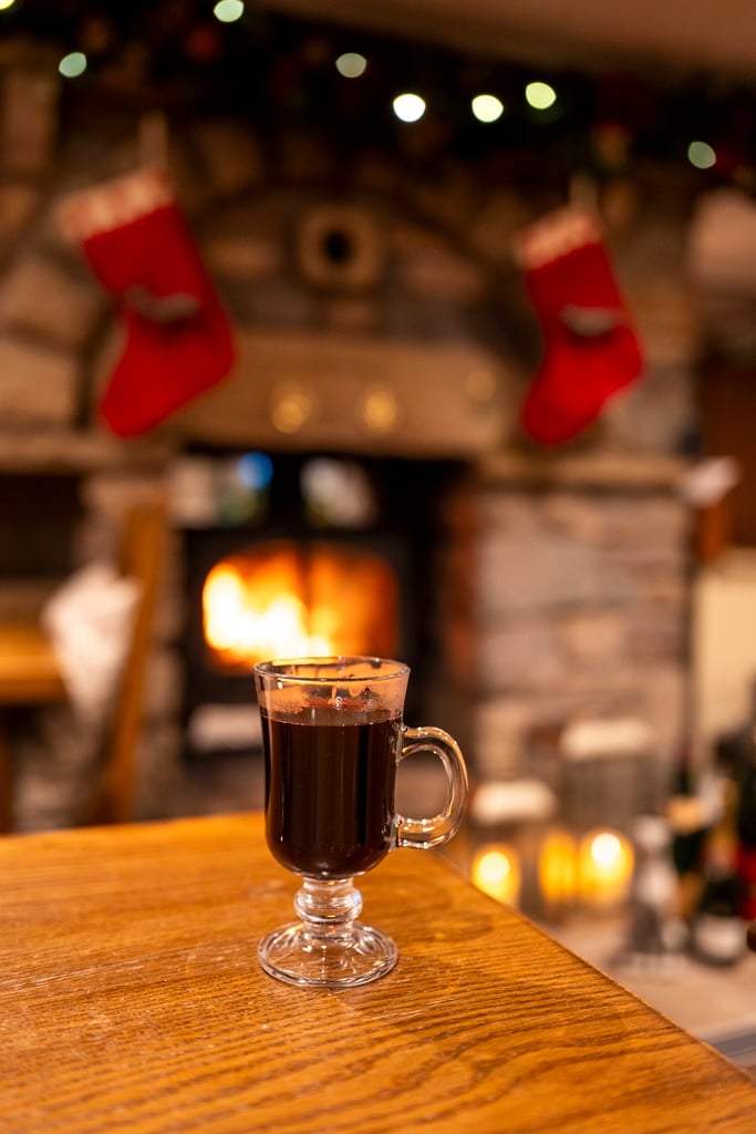 Mulled wine in a Christmas scene and stockings hanging in the background. Different events to try this christmas in the lake district