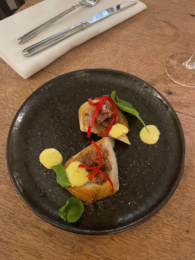 Plate of food in a pub in the Lake District. Knife and fork and drink