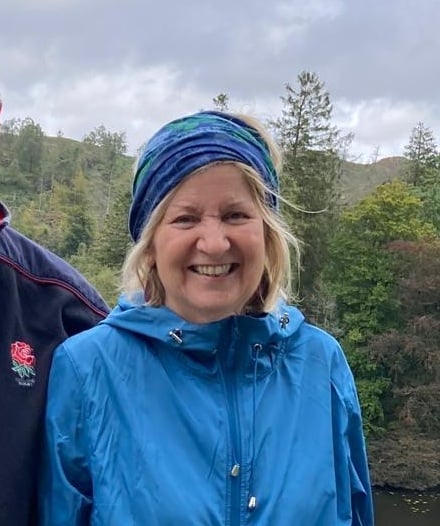 Woman in the Lake District enjoying a walk in the hills.