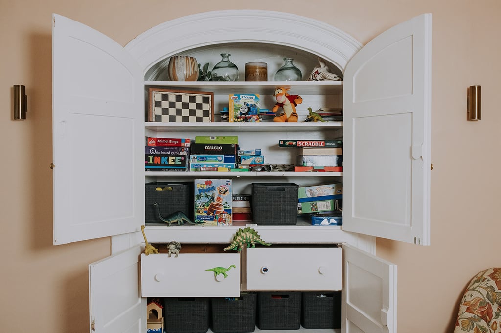 Games cupboard spilling with games and toys