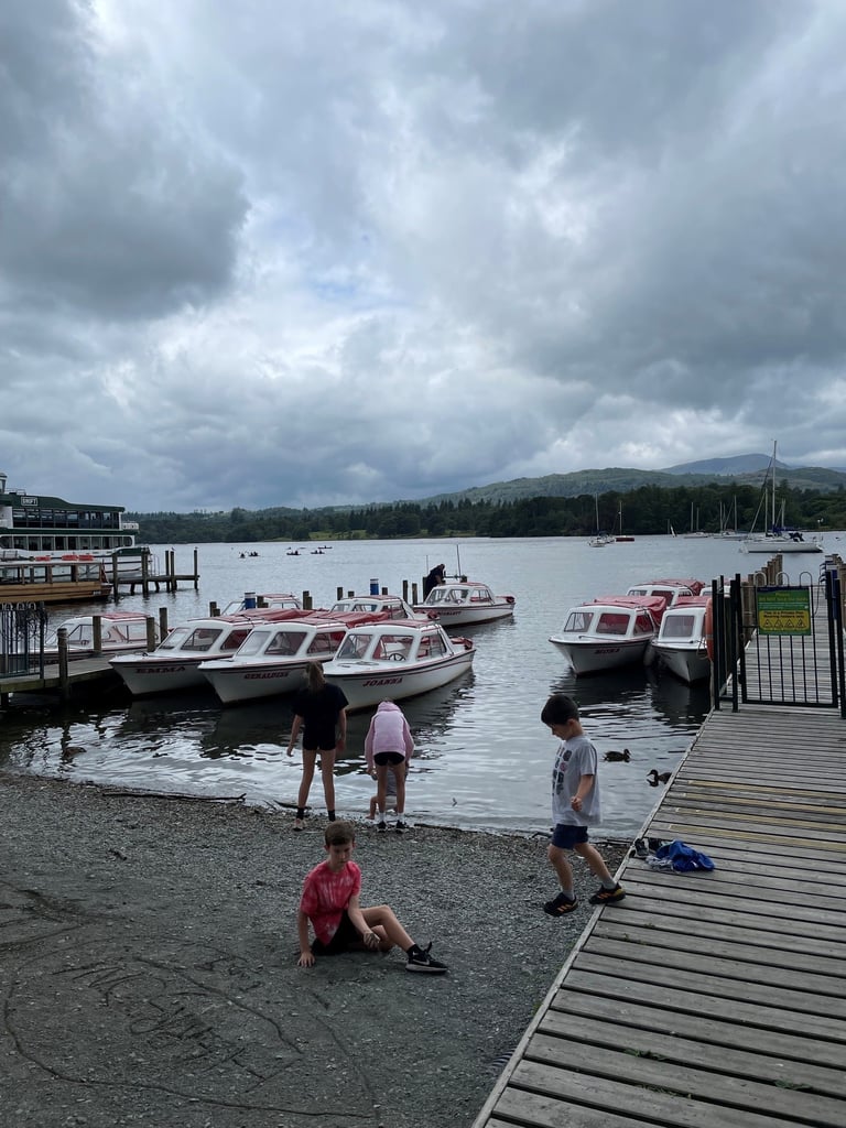 Boats on the shore of Ambleside and Windermere Jetty Boats to hire. Exploring the Lake District with kids at Lake Windermere